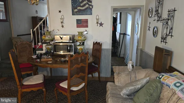 a living room with furniture a flat screen tv and a table