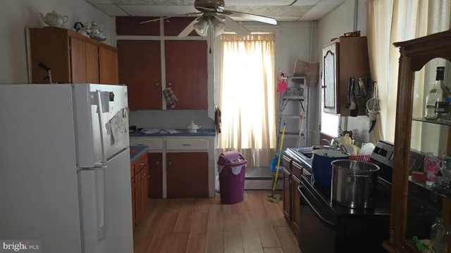 a kitchen with stainless steel appliances a refrigerator and a stove top oven