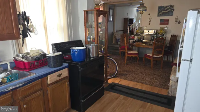 a kitchen with a refrigerator and dining table