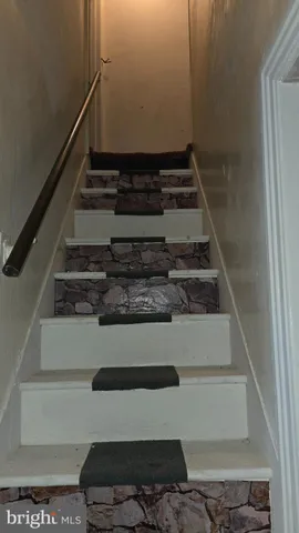 a bedroom with a bed and a flat tv screen on dresser