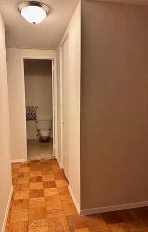 a bathroom with a granite countertop toilet sink and mirror