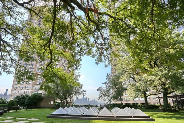 an aerial view of a house with a yard and lake view