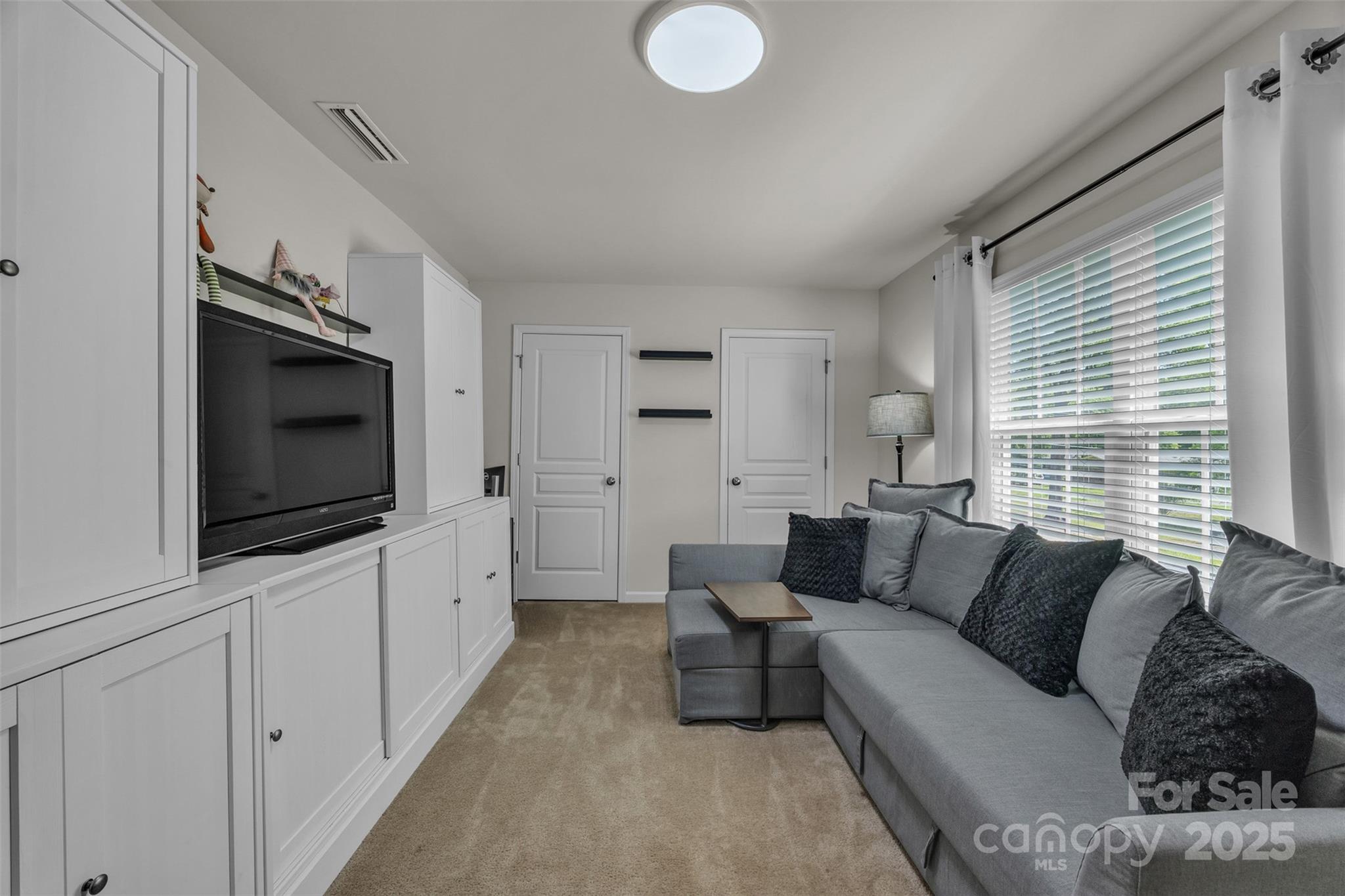 19455 Smith Circle Cornelius, NC 28031 - Photo 20 of 24 a living room with furniture and a flat screen tv