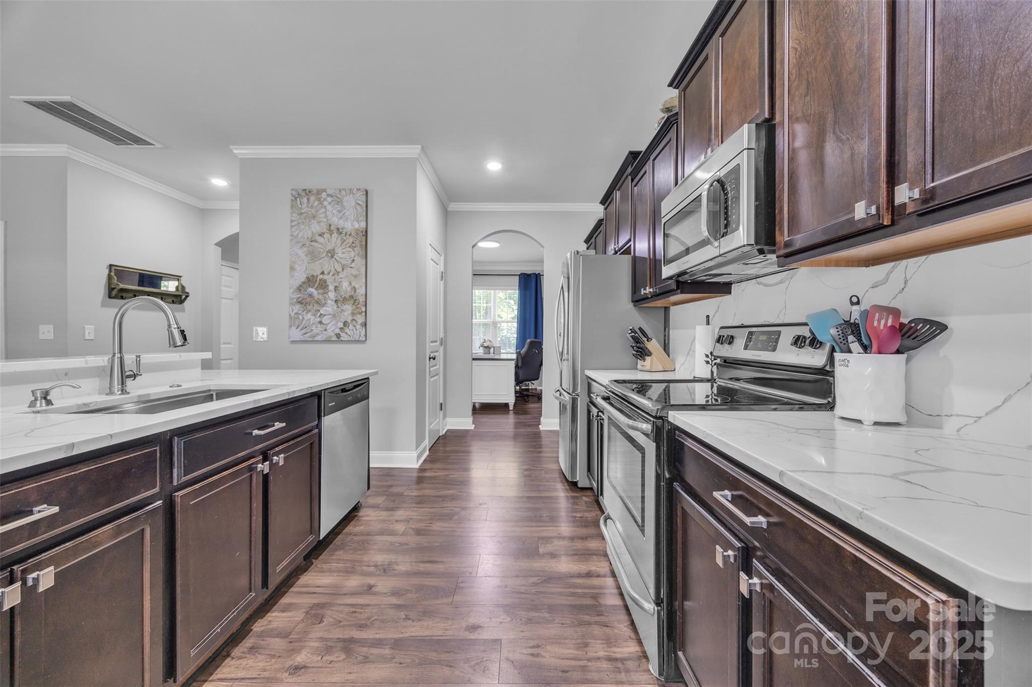 19455 Smith Circle Cornelius, NC 28031 - Photo 5 of 24 a kitchen with stainless steel appliances granite countertop a sink stove and cabinets