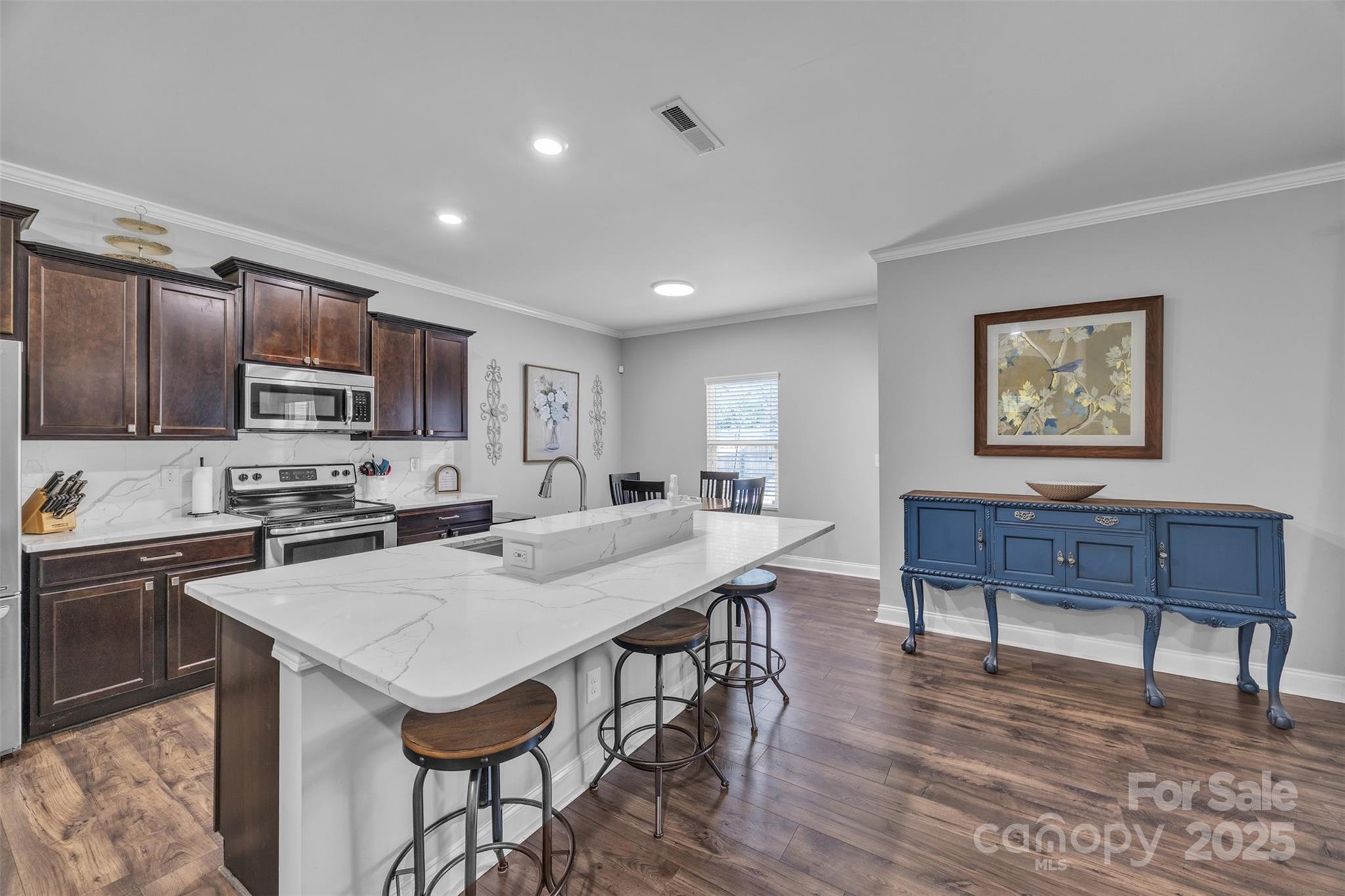 19455 Smith Circle Cornelius, NC 28031 - Photo 8 of 24 a view of kitchen with cabinets table and chairs