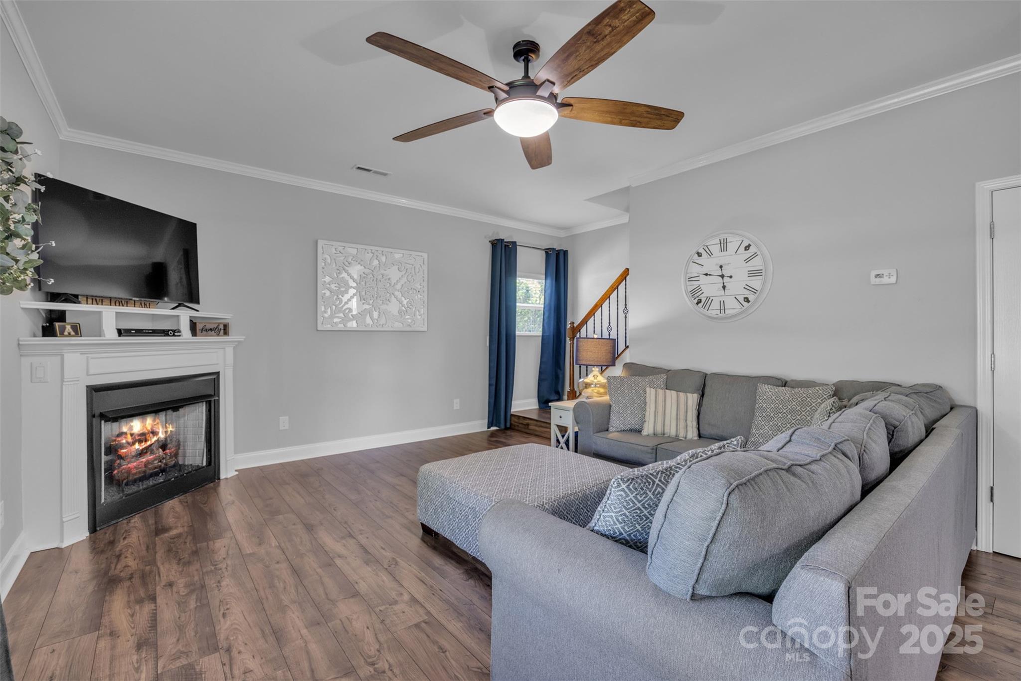 19455 Smith Circle Cornelius, NC 28031 - Photo 10 of 24 a living room with furniture a flat screen tv and a fireplace