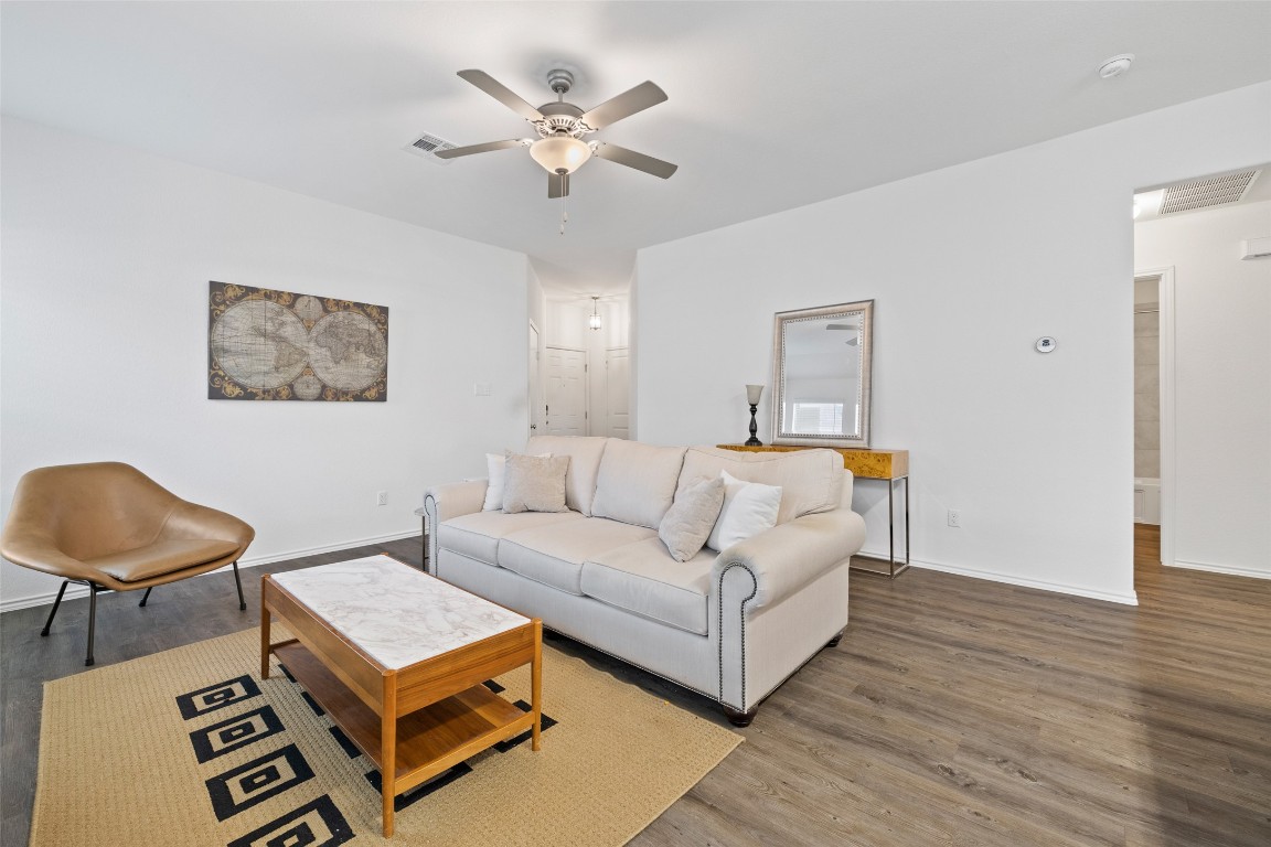 Living room with a ceiling fan and wood finished floors