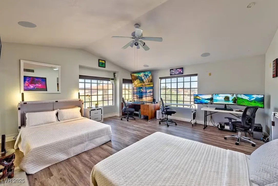 Bedroom with a desk, lofted ceiling, wood finished