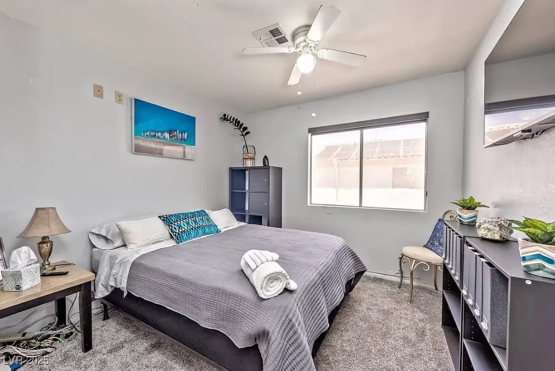 4823 Illustrious Street Las Vegas, NV 89147 - Photo 19 of 34 Carpeted bedroom with a ceiling fan and baseboards