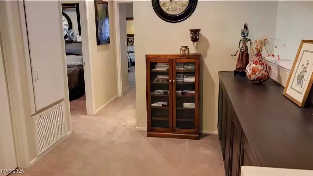 4823 Illustrious Street Las Vegas, NV 89147 - Photo 33 of 34 Hall featuring light colored carpet and baseboards