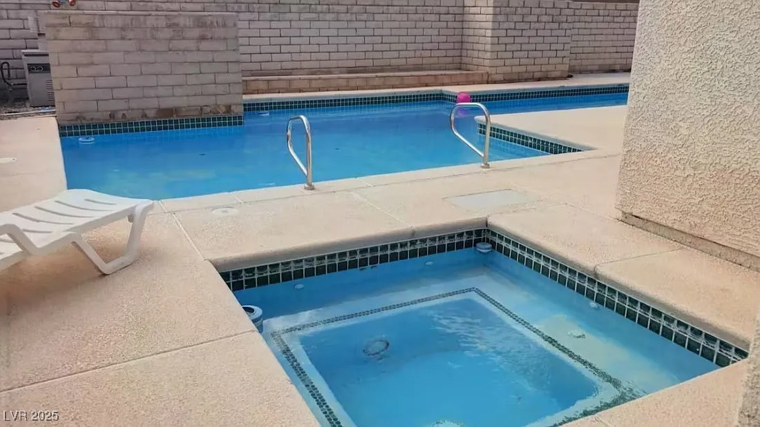 4823 Illustrious Street Las Vegas, NV 89147 - Photo 4 of 34 View of swimming pool featuring an in-ground hot t