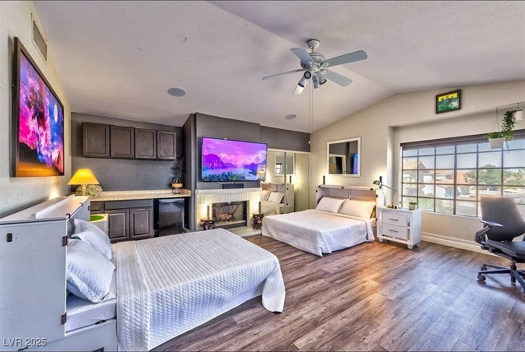 4823 Illustrious Street Las Vegas, NV 89147 - Photo 6 of 34 Bedroom featuring wood finished floors, vaulted ce