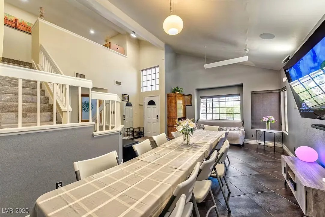 4823 Illustrious Street Las Vegas, NV 89147 - Photo 10 of 34 Dining room with ceiling fan, stairs, high vaulted
