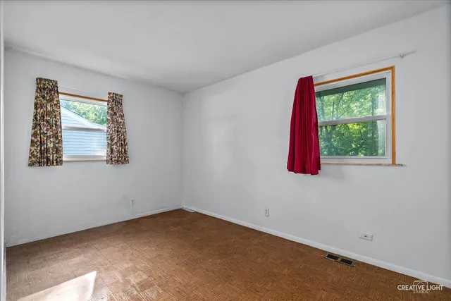 a view of a room with a window and a ceiling fan