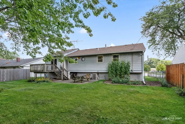 a view of a house with a yard and sitting area