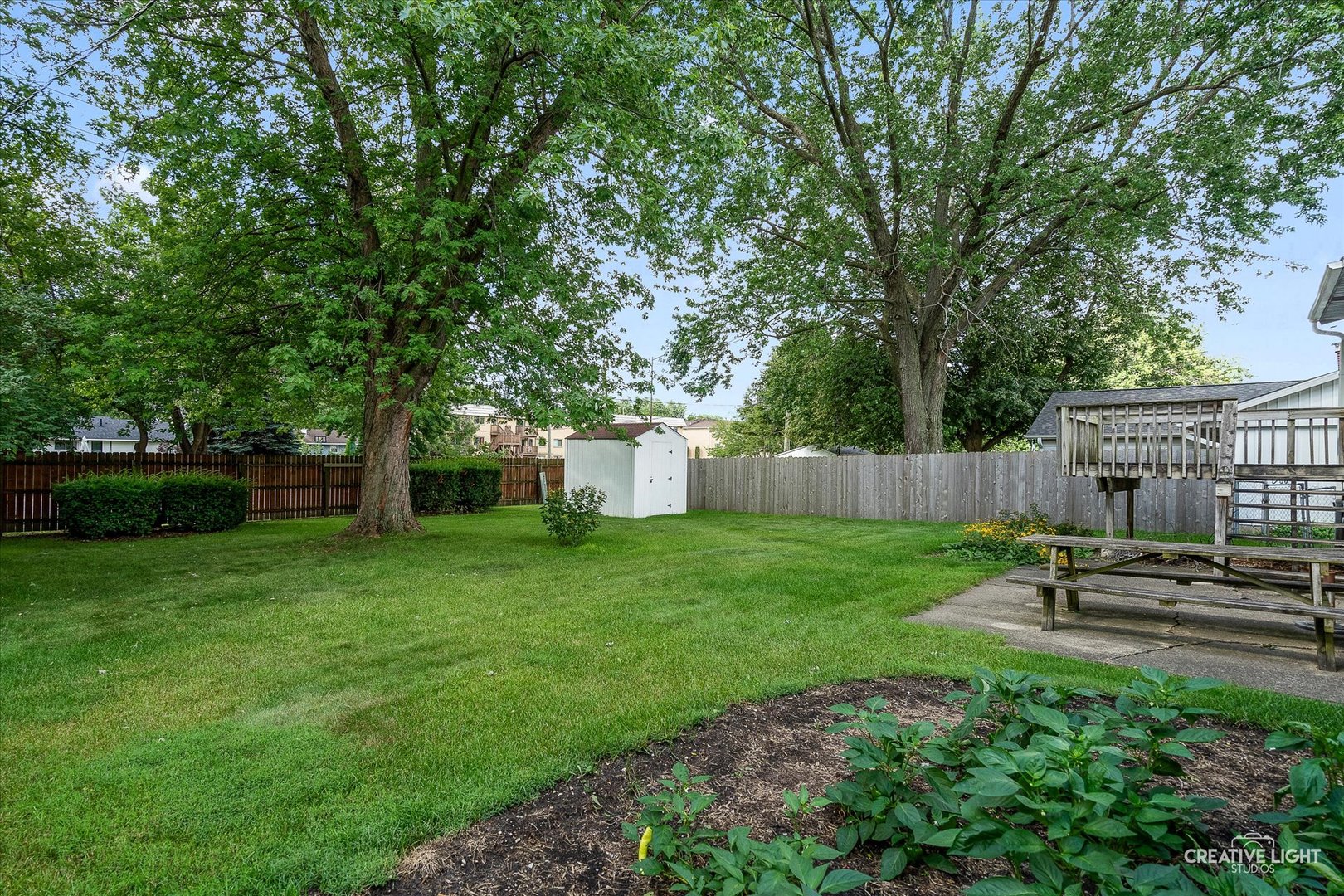 910 Southbridge Drive Aurora, IL 60506 - Photo 5 of 24 a view of a backyard with table and chairs and a large tree