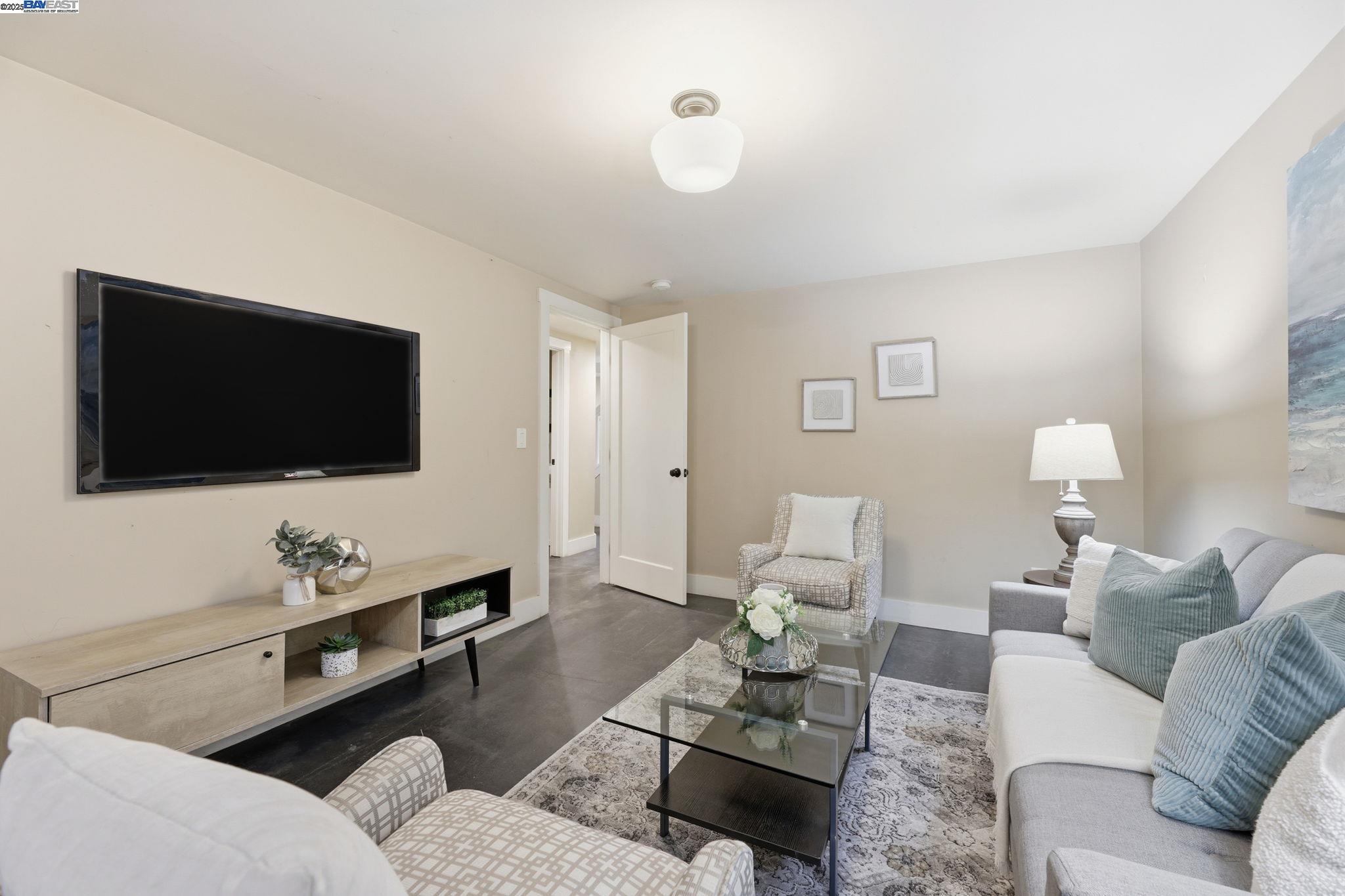2417 Linden Street Oakland, CA 94607 - Photo 11 of 41 a living room with furniture and a flat screen tv