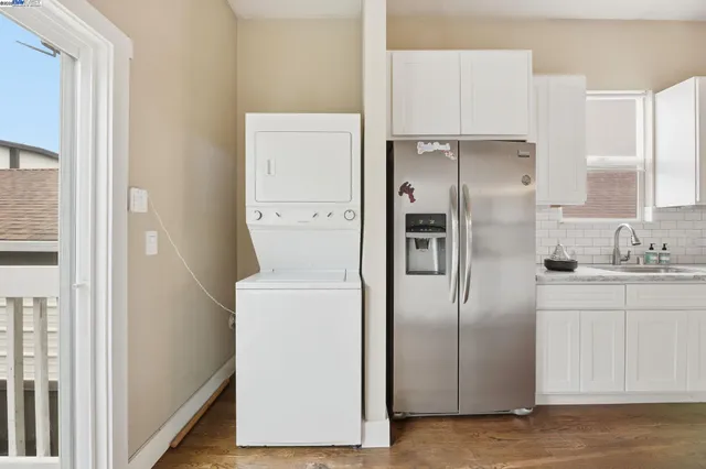 a kitchen with refrigerator a sink and cabinets