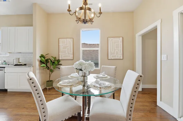 a view of a dining room with furniture wooden floor and chandelier