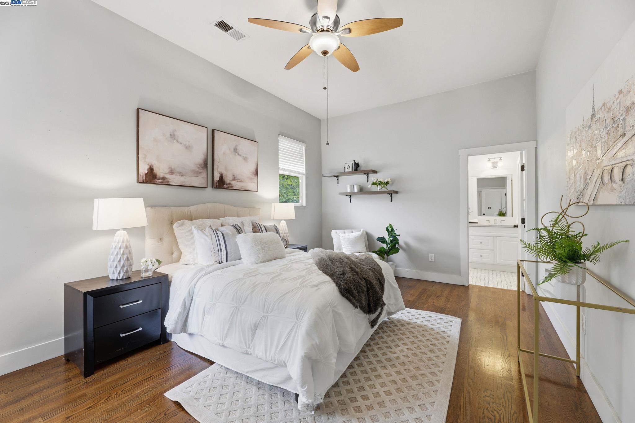 2417 Linden Street Oakland, CA 94607 - Photo 24 of 41 a bedroom with a bed and a chandelier