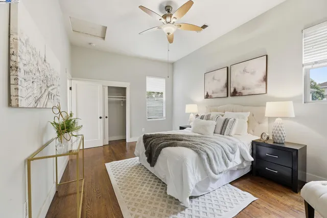a bedroom with a large bed and wooden floor