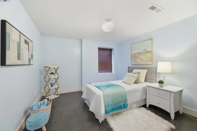 a bedroom with bed and a window