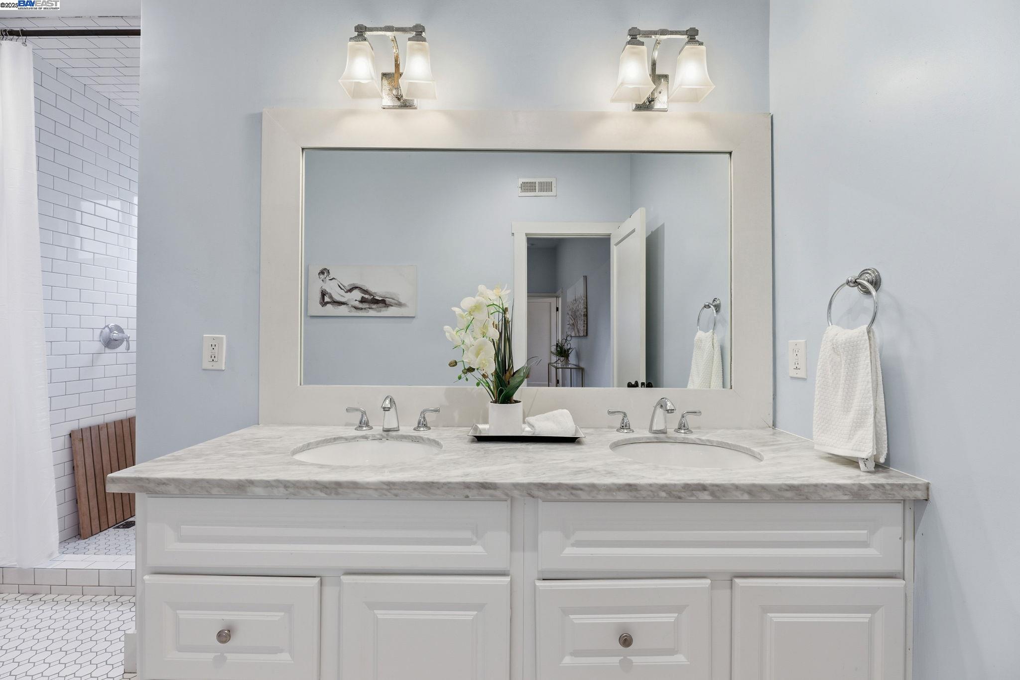 2417 Linden Street Oakland, CA 94607 - Photo 33 of 41 a bathroom with a sink and a mirror