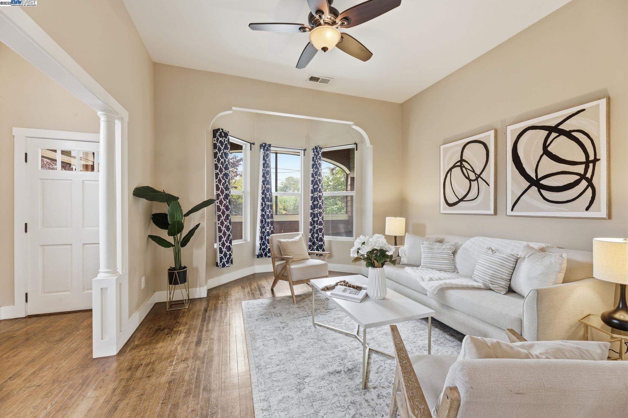 2417 Linden Street Oakland, CA 94607 - Photo 6 of 41 a living room with furniture floor to ceiling window and a rug