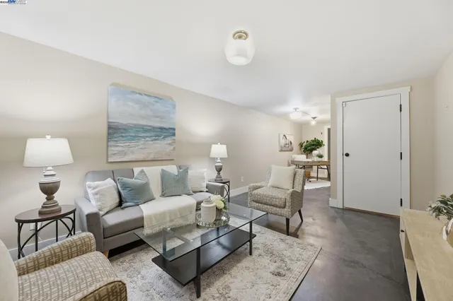 a living room with furniture and a lamp