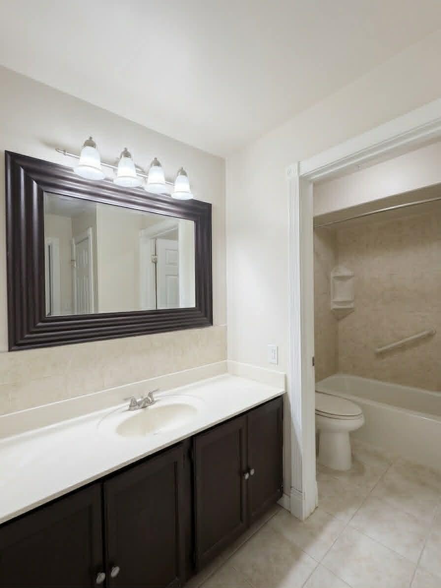 2003 West 45th Street, Unit 207 Highland, IN 46322 - Photo 6 of 13 a bathroom with a toilet sink double vanity and mirror