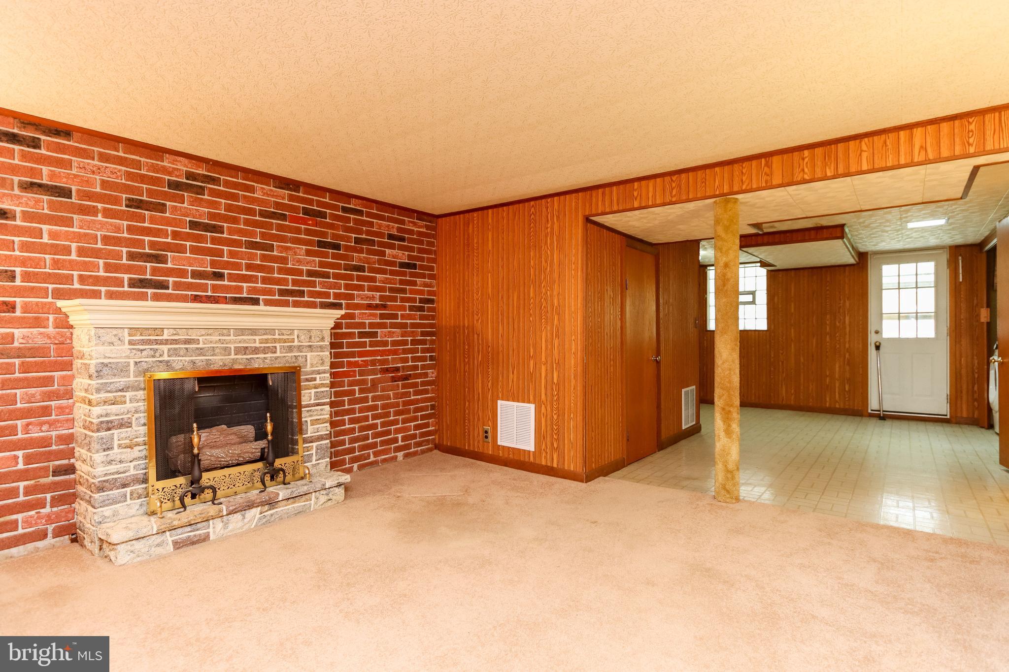 1631 Hardwick Road Baltimore, MD 21286 - Photo 18 of 46 Fireplace is against a brick accent wall.