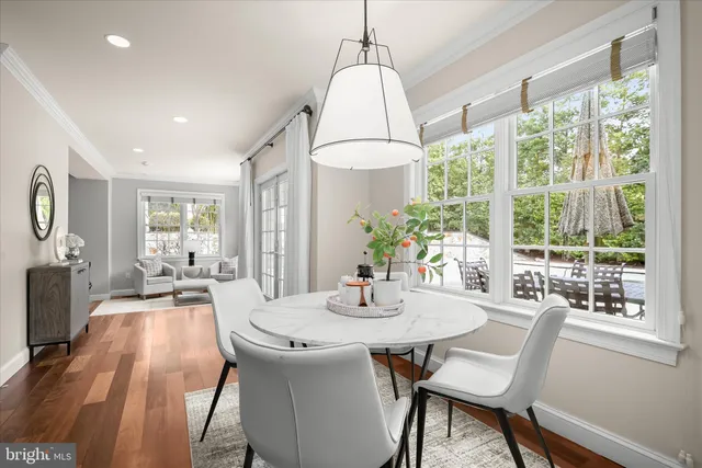 a kitchen with stainless steel appliances granite countertop white cabinets and a stove top oven
