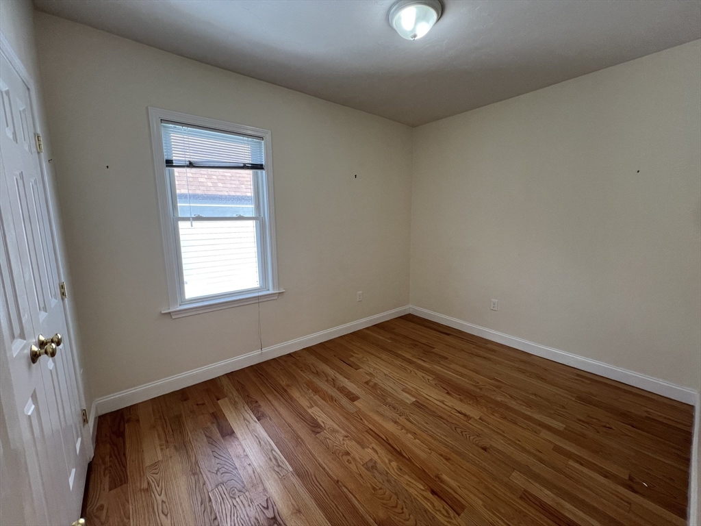 12 Weld Hill Street, Unit 2 Boston, MA 02130 - Photo 8 of 9 an empty room with wooden floor and windows