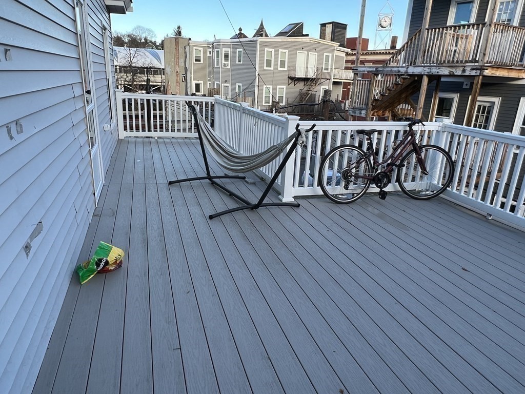 12 Weld Hill Street, Unit 2 Boston, MA 02130 - Photo 9 of 9 a view of a roof deck with wooden floor and fence