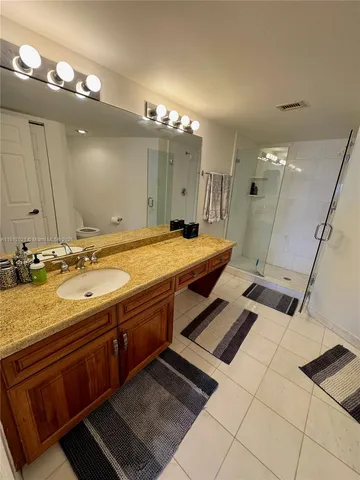 a bathroom with a sink double vanity granite and a mirror