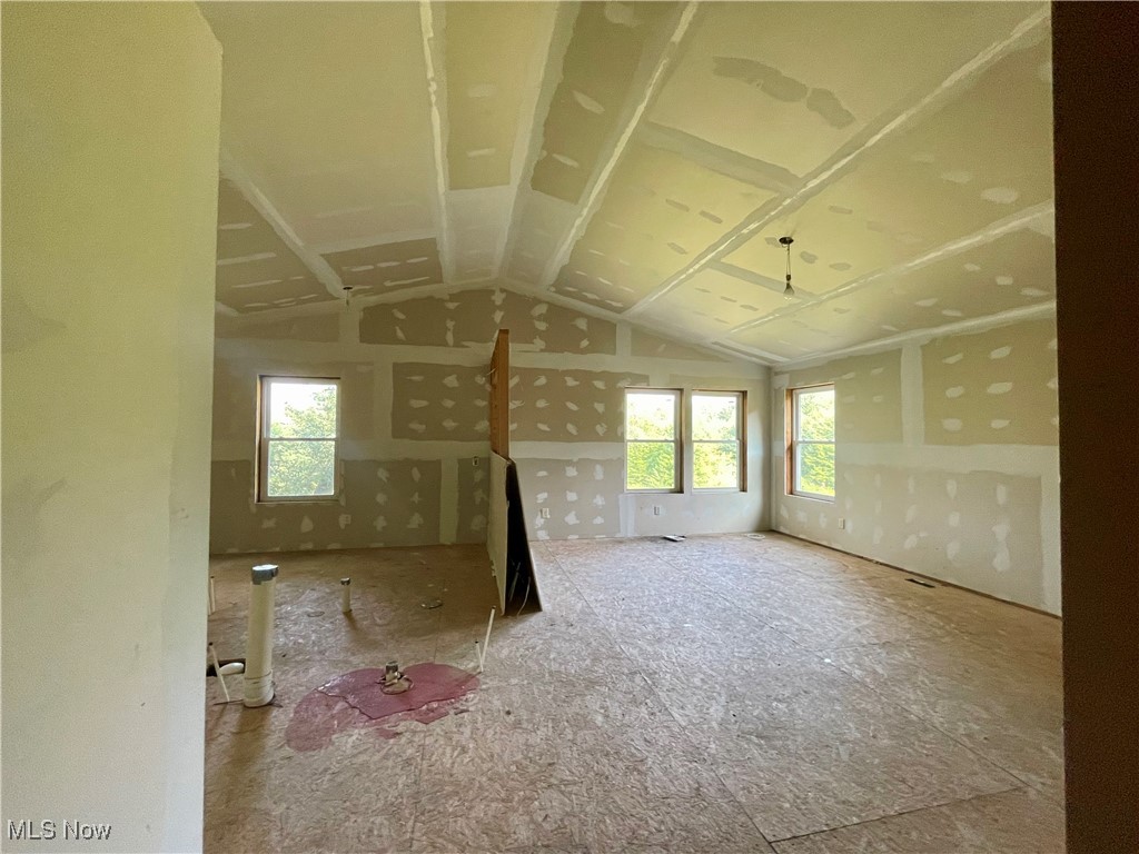 35 Arbor Road Northeast Minerva, OH 44657 - Photo 12 of 15 Unfurnished room featuring vaulted ceiling and a wealth of natural light