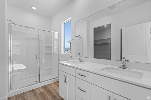 2823 North 710 West, Unit 16 Logan, UT 84321 - Photo 10 of 22 Full bath with a stall shower, double vanity, light wood-style floors, a spacious closet, and recessed lighting