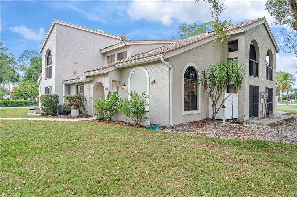 940 Augusta Boulevard, Unit D939 Naples, FL 34113 - Photo 2 of 42 a front view of a house with garden