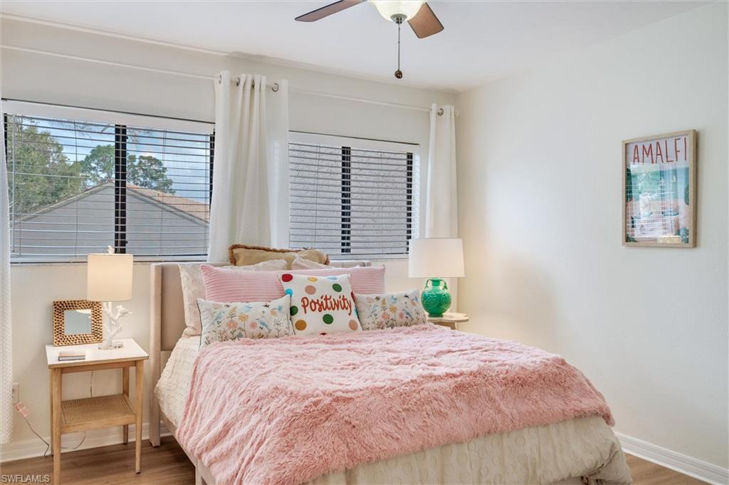 940 Augusta Boulevard, Unit D939 Naples, FL 34113 - Photo 23 of 42 a bedroom with a large bed and a window