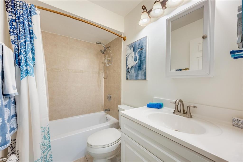 940 Augusta Boulevard, Unit D939 Naples, FL 34113 - Photo 25 of 42 a bathroom with a sink toilet and shower
