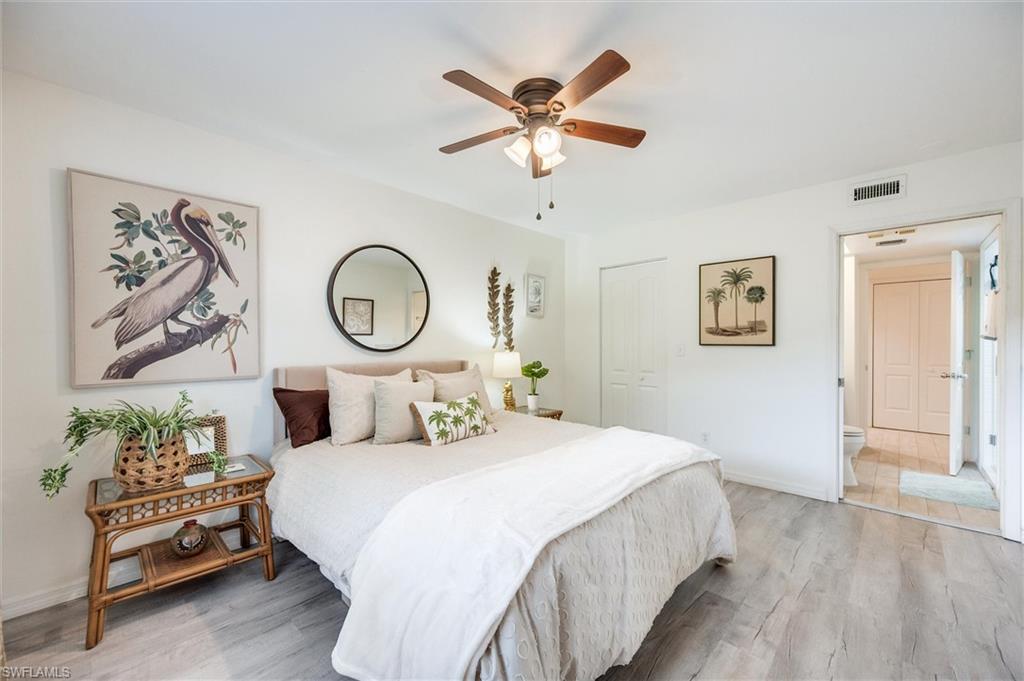 940 Augusta Boulevard, Unit D939 Naples, FL 34113 - Photo 28 of 42 a bedroom with bed and a chandelier