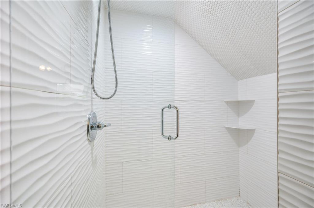 940 Augusta Boulevard, Unit D939 Naples, FL 34113 - Photo 30 of 42 a bathroom with a shower