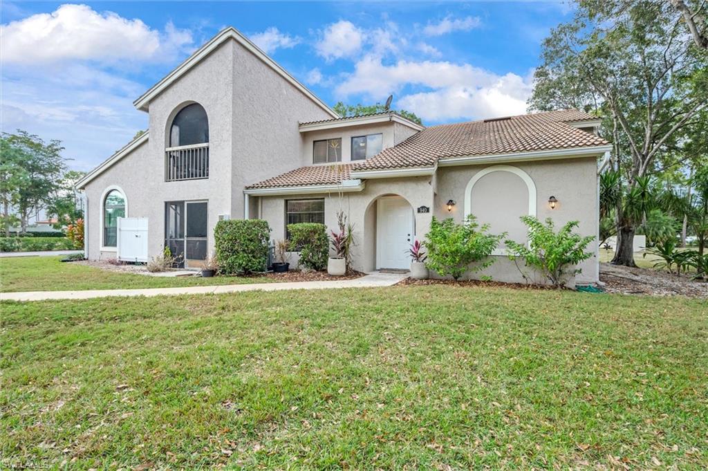 940 Augusta Boulevard, Unit D939 Naples, FL 34113 - Photo 31 of 42 a front view of a house with a garden
