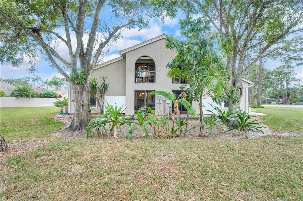 940 Augusta Boulevard, Unit D939 Naples, FL 34113 - Photo 32 of 42 a front view of a house with garden