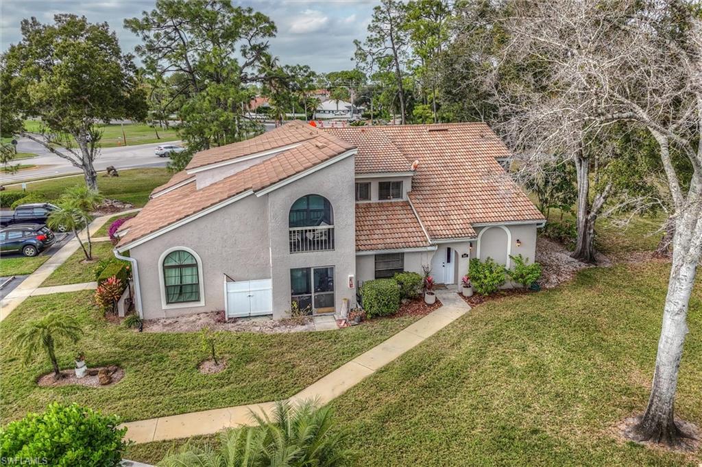 940 Augusta Boulevard, Unit D939 Naples, FL 34113 - Photo 35 of 42 a view of a house with a yard