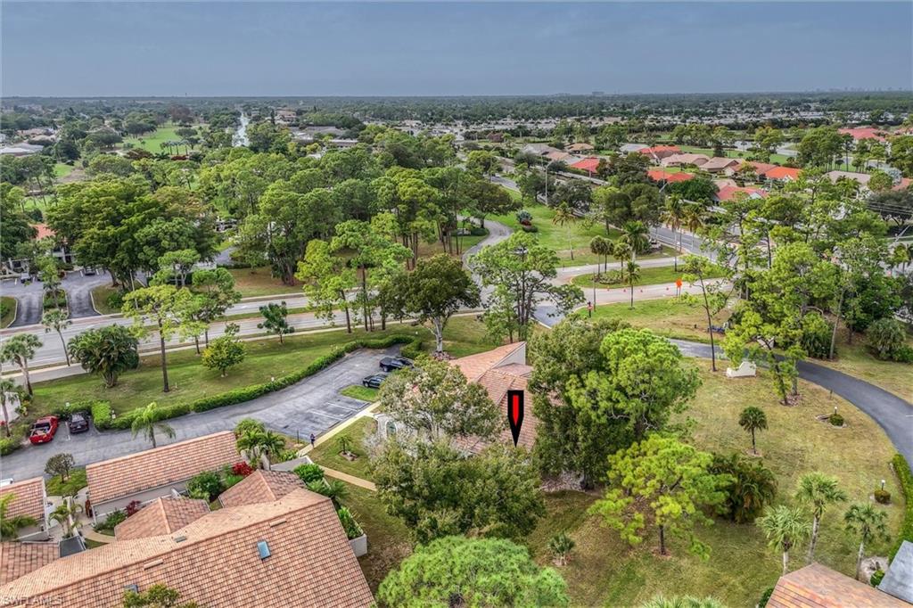 940 Augusta Boulevard, Unit D939 Naples, FL 34113 - Photo 37 of 42 an aerial view of residential houses with outdoor space and trees