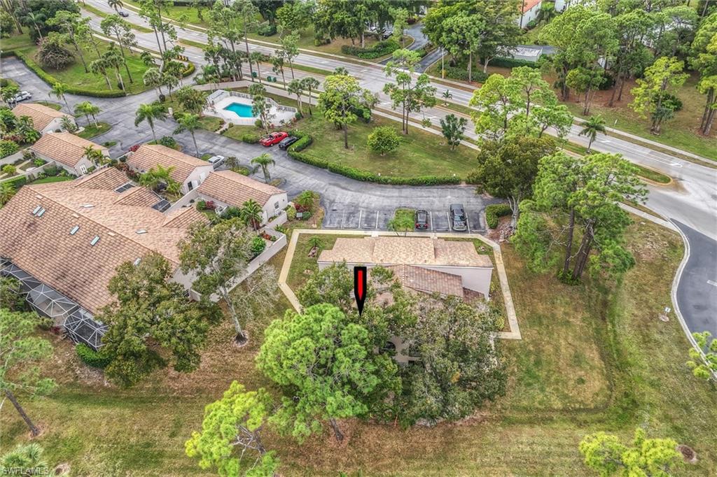 940 Augusta Boulevard, Unit D939 Naples, FL 34113 - Photo 40 of 42 an aerial view of a house with a yard and lake view