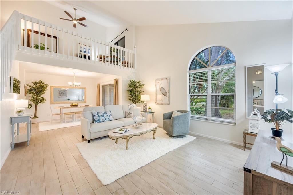 940 Augusta Boulevard, Unit D939 Naples, FL 34113 - Photo 4 of 42 a living room with furniture and a large window
