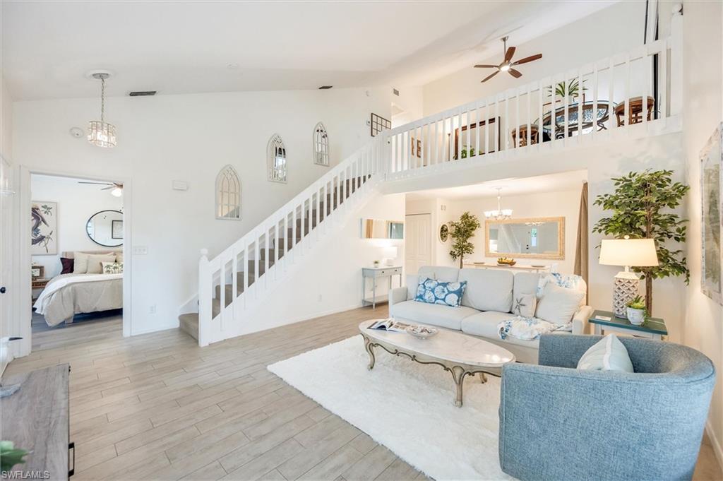 940 Augusta Boulevard, Unit D939 Naples, FL 34113 - Photo 5 of 42 a living room with furniture and a chandelier