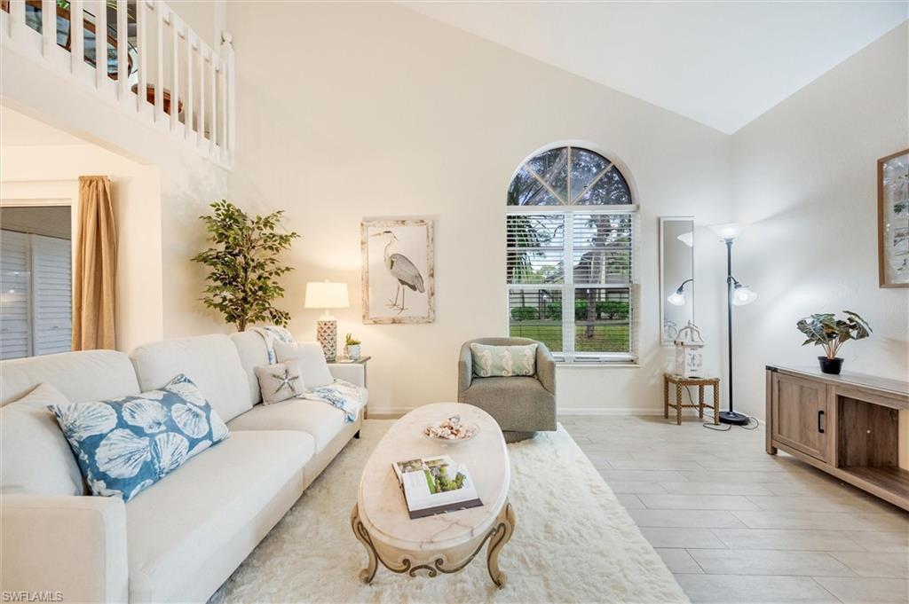 940 Augusta Boulevard, Unit D939 Naples, FL 34113 - Photo 6 of 42 a living room with furniture and a large window